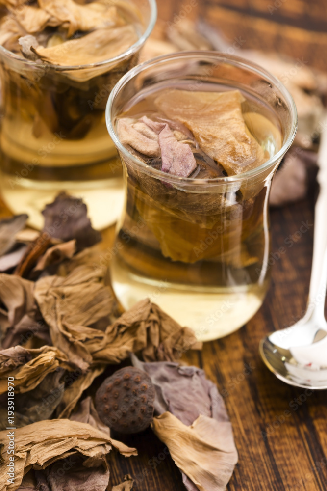 Lotus petals tea on wooden background Lotus petals tea on wooden background