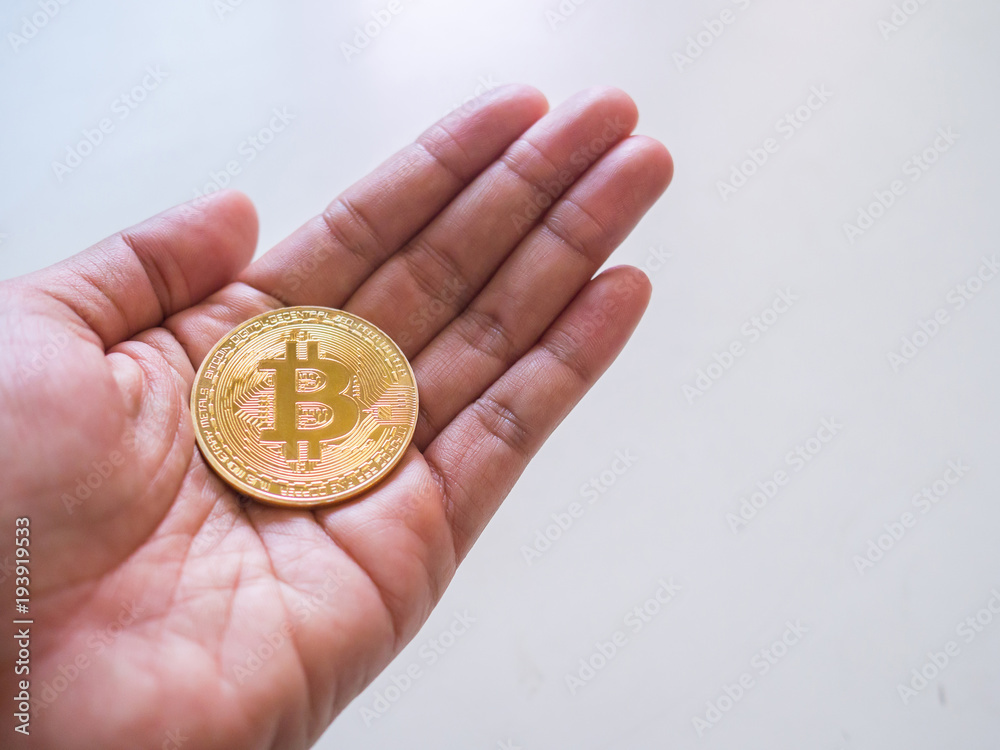 Bitcoin in woman's hand on white background, cryptocurrency investment concept. Bitcoin in woman's hand on white background, cryptocurrency investment concept.