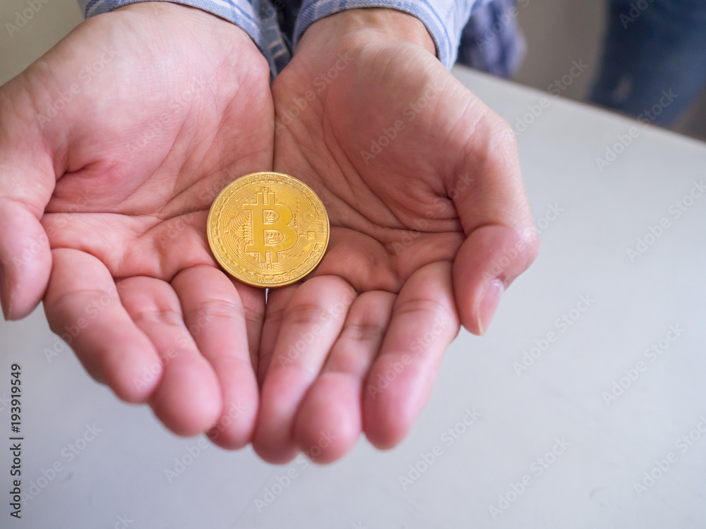 Bitcoin in man's hand, investment concept. Bitcoin in man's hand, investment concept.