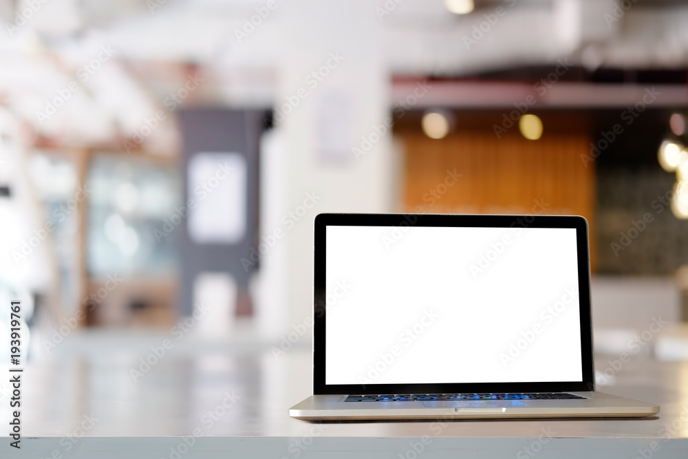 Workspace modern laptop computer on a white wooden desk with office background Workspace modern laptop computer on a white wooden desk with office background