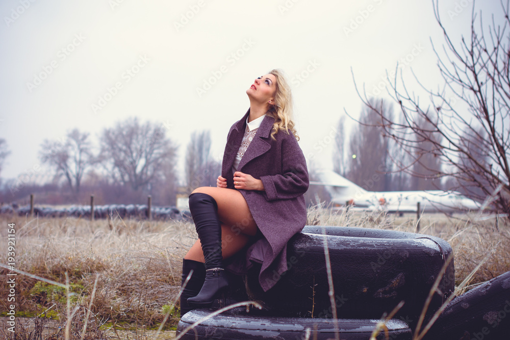 Retro style picture of a traveler in the old airport, girl in retro style wear vintage look Retro style picture of a traveler in the old airport, girl in retro style wear vintage look