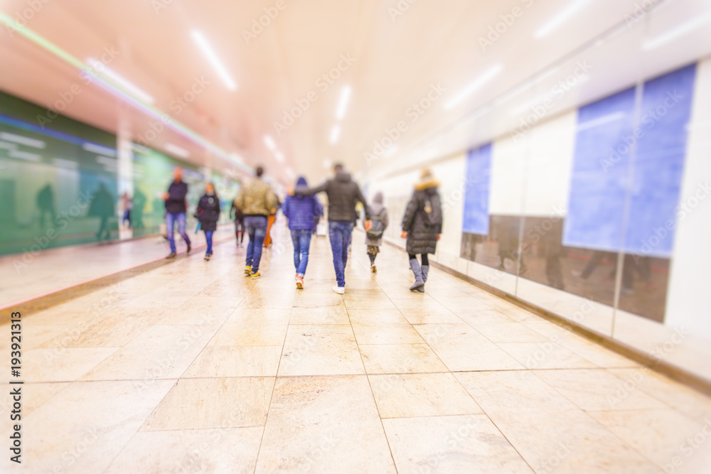 Crowd of anonymous people walking on busy metro station 