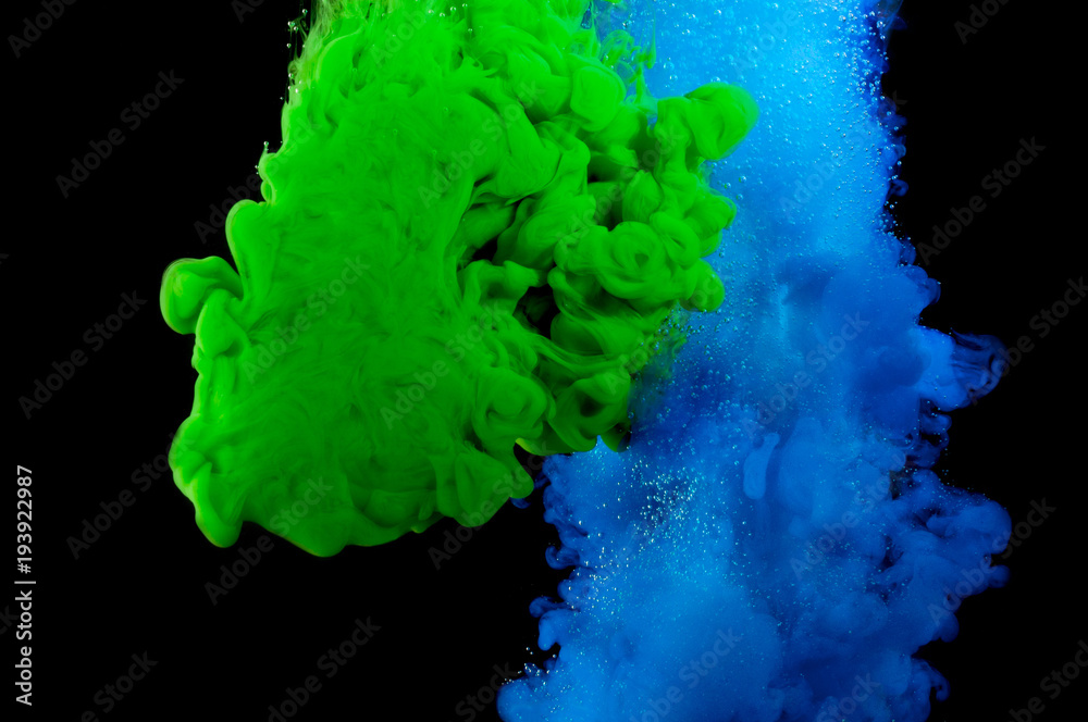 Color paint in water on a black background