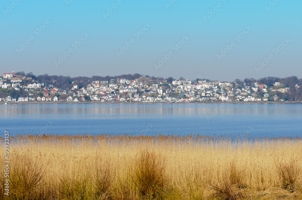 View from southern banks of Elbe River at Blankenese village at fine weather. View from southern banks of Elbe River at Blankenese village at fine weather.