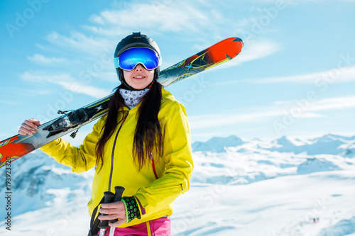 Photo of cheerful girl in helmet and mask with skis photo