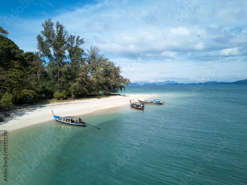 Aerial View of beach on Thai island with longtail boats photo