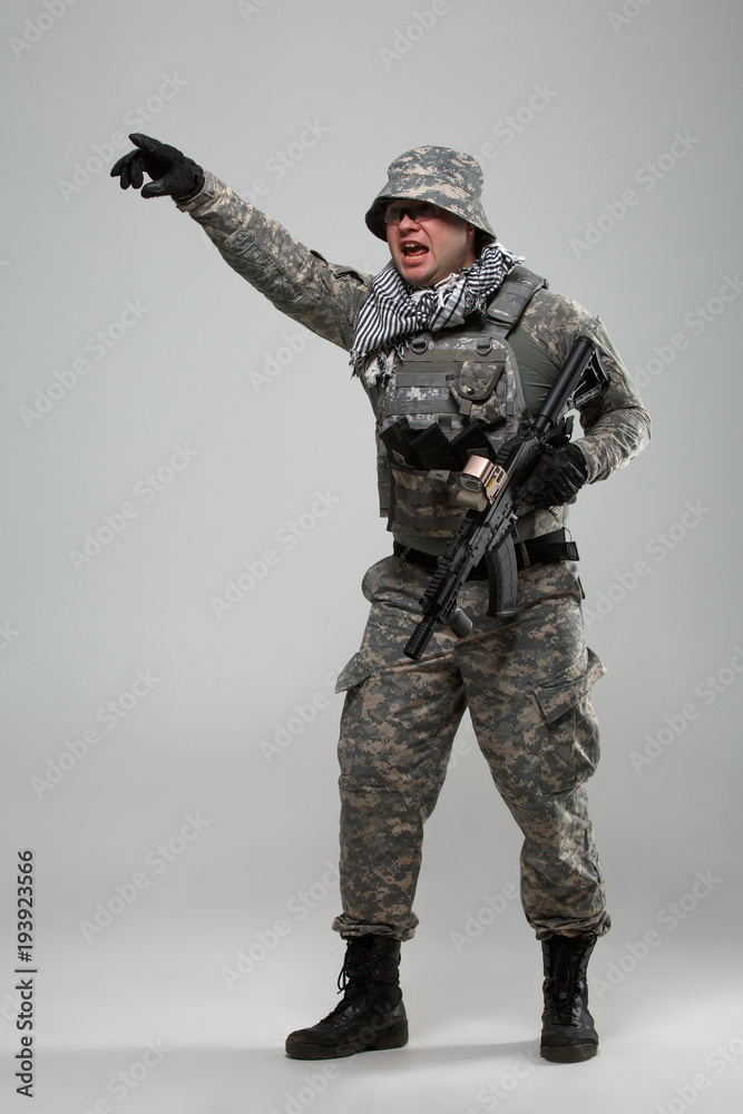 Full-length picture of military man in helmet with hand pointing Full-length picture of military man in helmet with hand pointing
