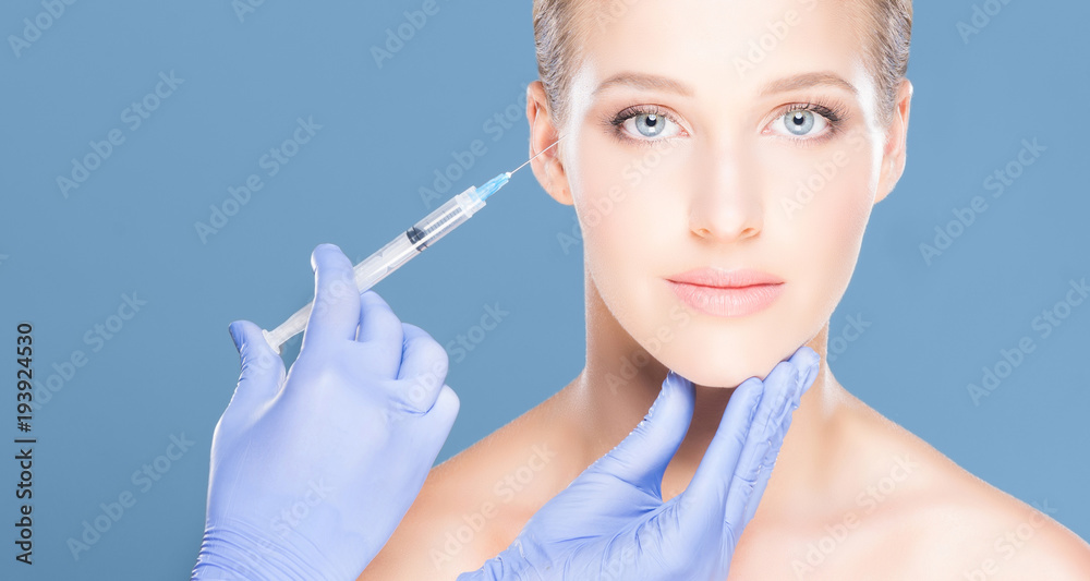 Doctor injecting in a beautiful face of a young woman. Plastic s Doctor injecting in a beautiful face of a young woman. Plastic s