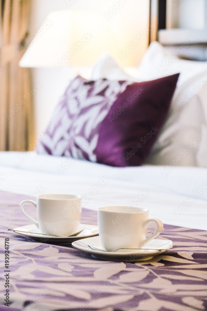 White coffee cup on bed