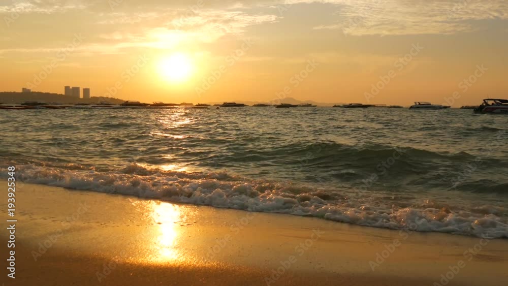 Very beautiful sunset on the seashore. Sandy beach and waves that beat on beach Very beautiful sunset on the seashore. Sandy beach and waves that beat on beach