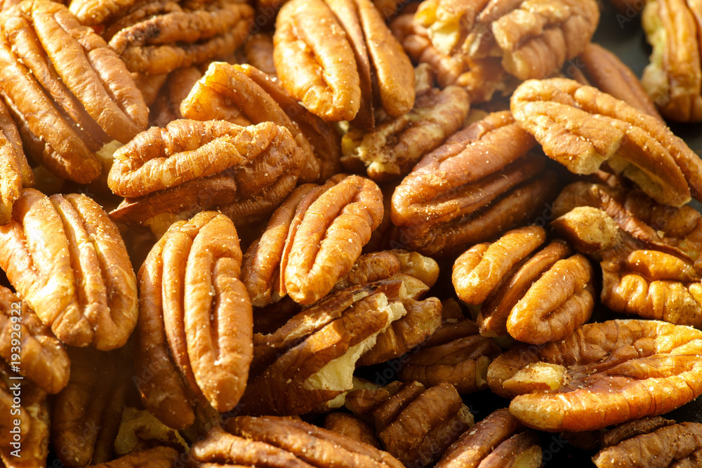 Pecans nuts. A close-up photograph. Unrefined whole kernel Pecans nuts. A close-up photograph. Unrefined whole kernel