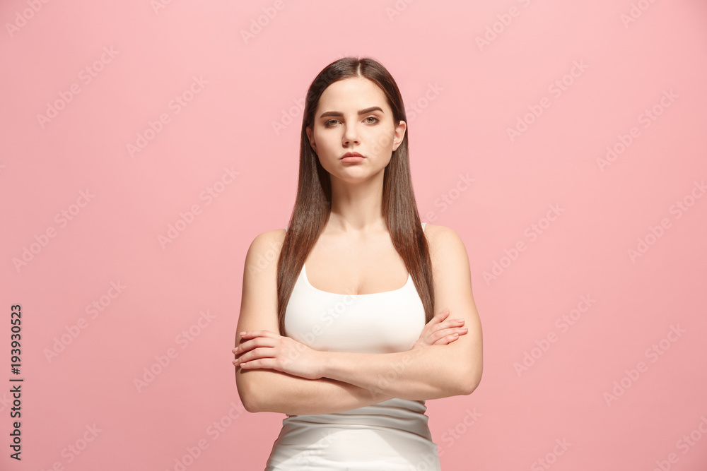 Φωτογραφία The serious business woman standing and looking at camera against pink background