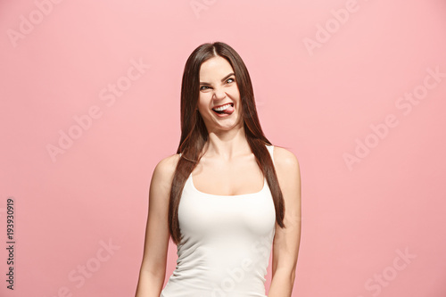 The squint eyed woman with weird expression isolated on pink