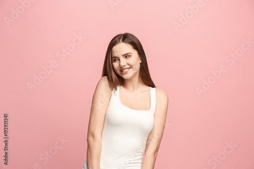 Let me think. Doubtful pensive woman with thoughtful expression making choice against pink background