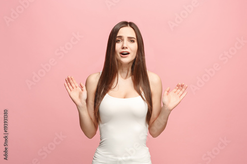 Beautiful woman looking suprised isolated on pink
