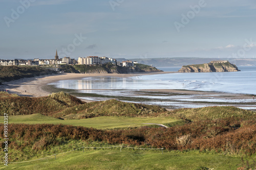 On the Coastpath looking across the Golf Course and Tenby South Beach to Tenby Pembrokeshire Wales photo