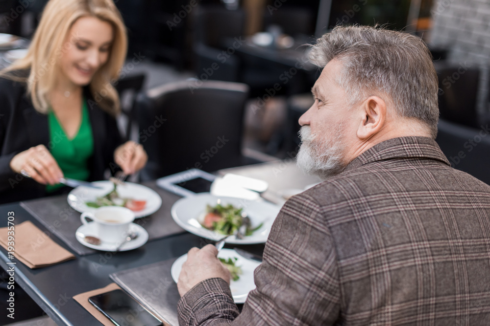 selective focus of senior man on romantic date with girlfriend in cafe selective focus of senior man on romantic date with girlfriend in cafe