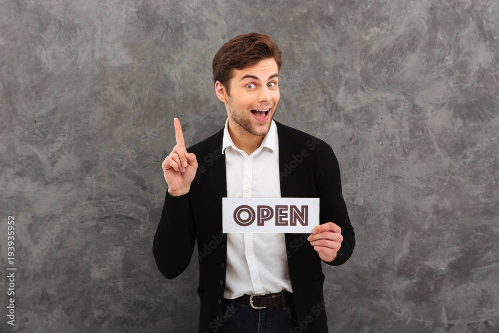 Cheerful young businessman looking camera have an idea. Cheerful young businessman looking camera have an idea.