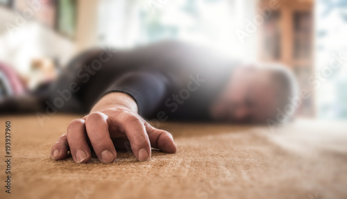 a man lies unconscious in his apartment
 photo