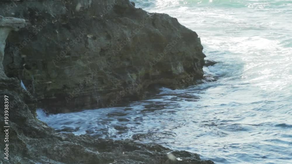 Ocean waves crash and splash water on coastal rock Ocean waves crash and splash water on coastal rock