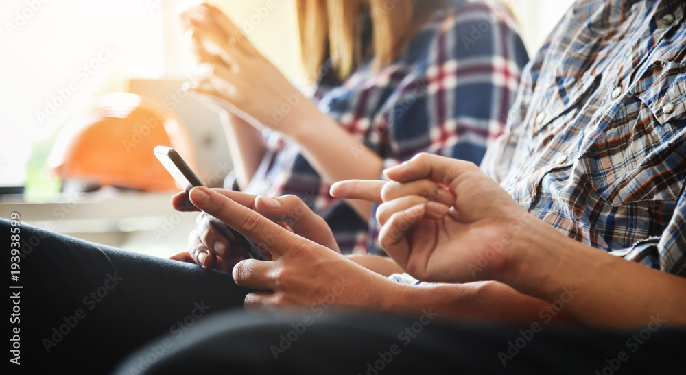 Group students are using cell phones. Group students are using cell phones.