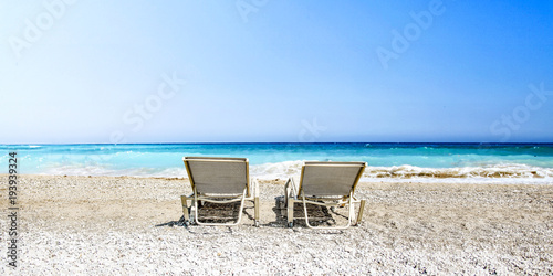 Fototapeta Naklejka Na Ścianę i Meble -  sunbed on beach and blue ocean 