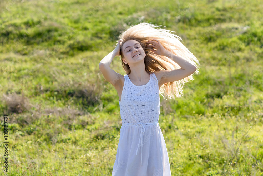 teenager girl is swaying her hair outdoor teenager girl is swaying her hair outdoor