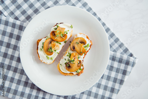 toast with cream cheese fried mushrooms and sprout top view