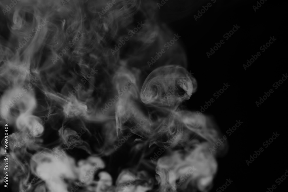 White smoke on a black background. Texture of smoke. Clubs of wh White smoke on a black background. Texture of smoke. Clubs of wh