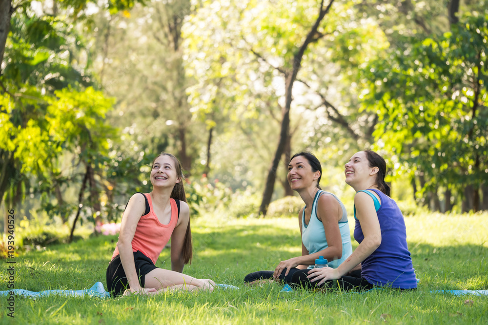 Activities in the family, mother and daughter relaxing in the park after practicing yoga. Activities in the family, mother and daughter relaxing in the park after practicing yoga.