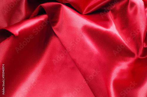 Texture, background, pattern. Red silk fabric.This satin fabric is perfect for making fabric flowers for use in hair accessories, jewery making, and fabric bouquets.