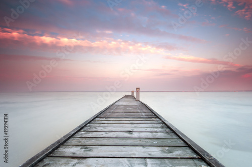 Minimalistic landscape with old jetty.Long exposure shot. photo
