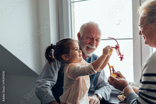 Showing new toy to her grandparents photo
