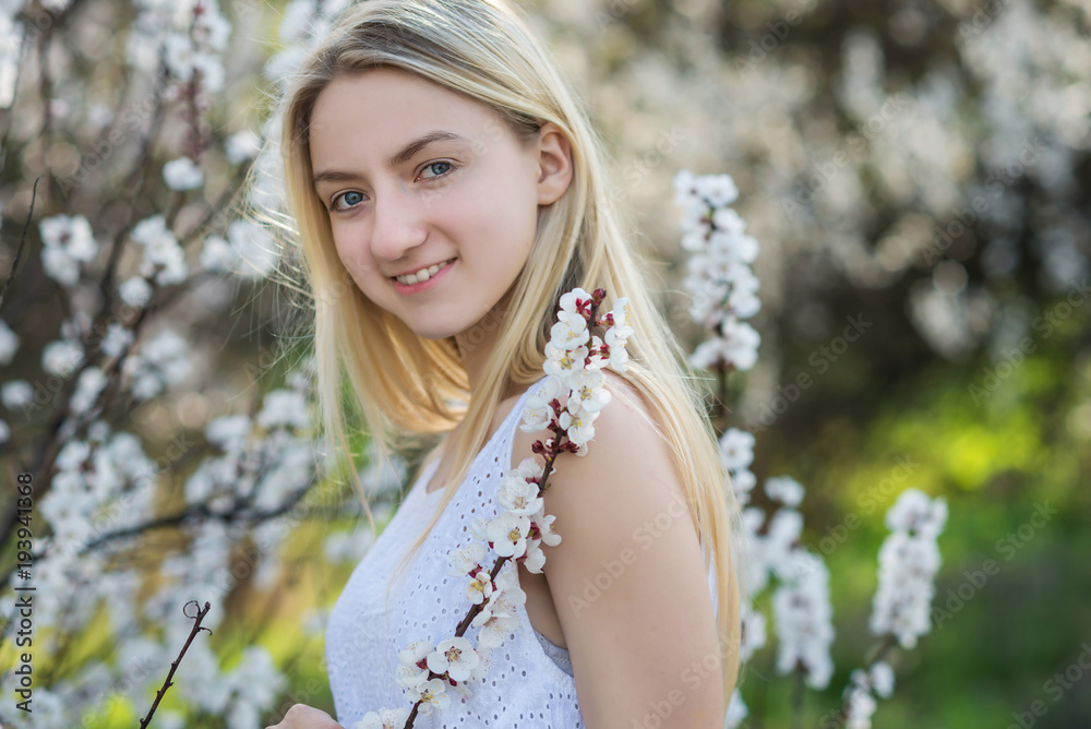 Teenage girl in blooming apricot garden Teenage girl in blooming apricot garden