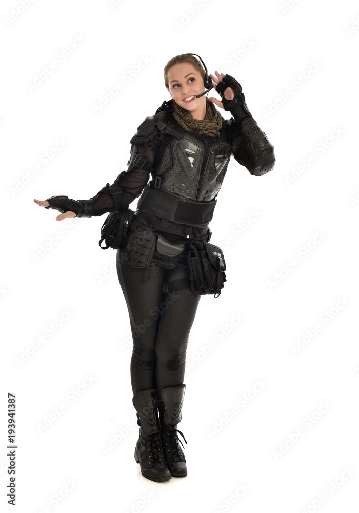 full length portrait of female soldier wearing black tactical armour, isolated on white studio background. full length portrait of female soldier wearing black tactical armour, isolated on white studio background.