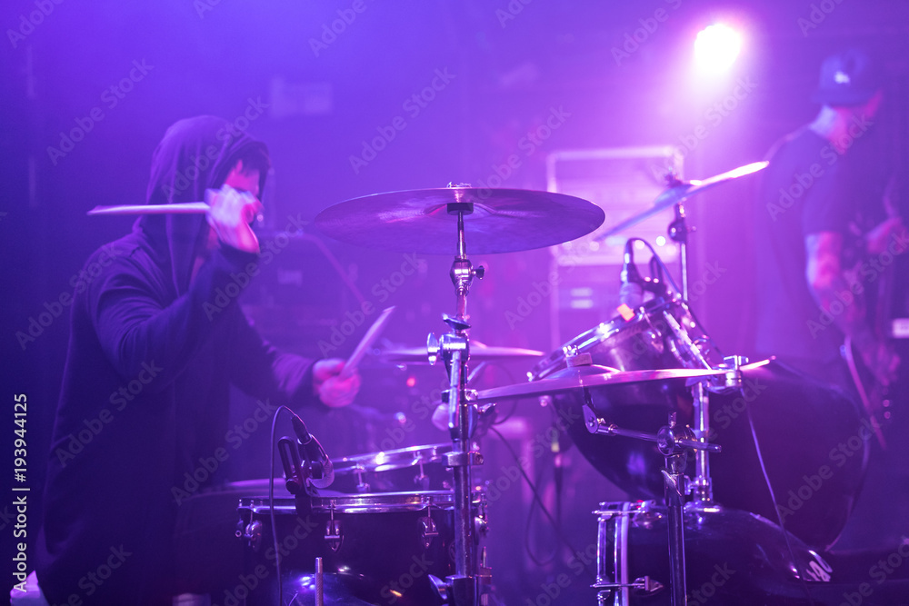 Obraz premium Rocker drummer is playing on stage.