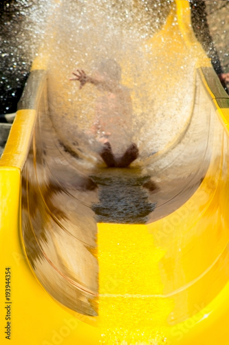 Wallpaper Mural child rides down a water slide in a cloud of spray Torontodigital.ca