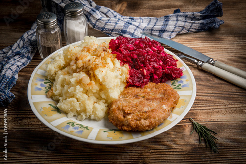 Photography Pork cutlet with minced meat served with boiled potatoes and beetroot