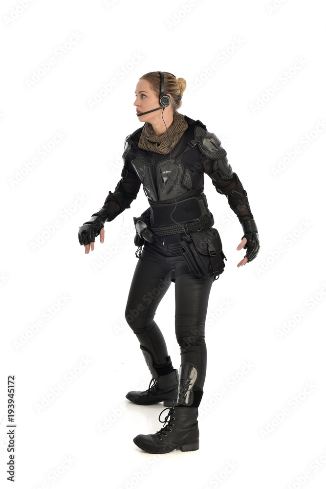 full length portrait of female soldier wearing black tactical armour, isolated on white studio background. full length portrait of female soldier wearing black tactical armour, isolated on white studio background.