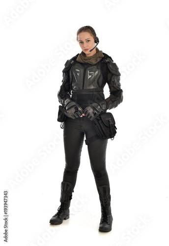 full length portrait of female  soldier wearing black  tactical armour, isolated on white studio background. © faestock