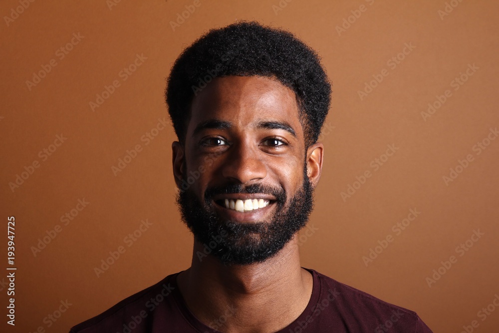 Afro man in front of a brown background Afro man in front of a brown background