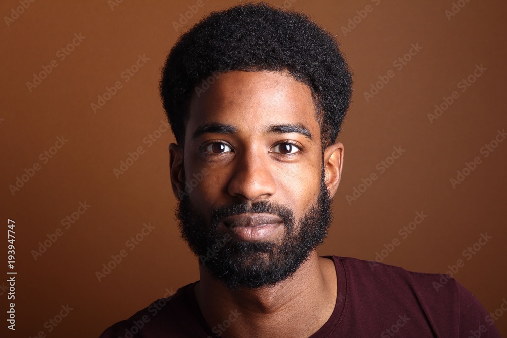 Obraz premium Afro man in front of a brown background