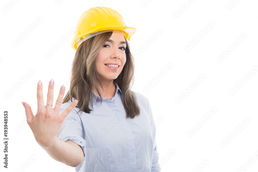 Portrait of female constructor showing number five. Portrait of female constructor showing number five.