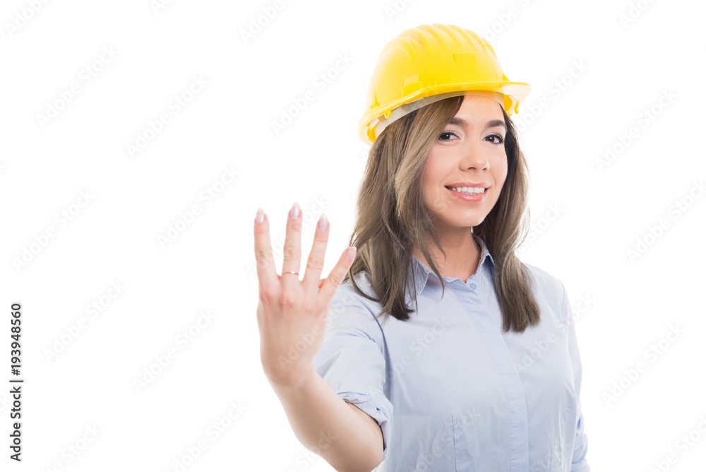 Portrait of female constructor showing number four. Portrait of female constructor showing number four.