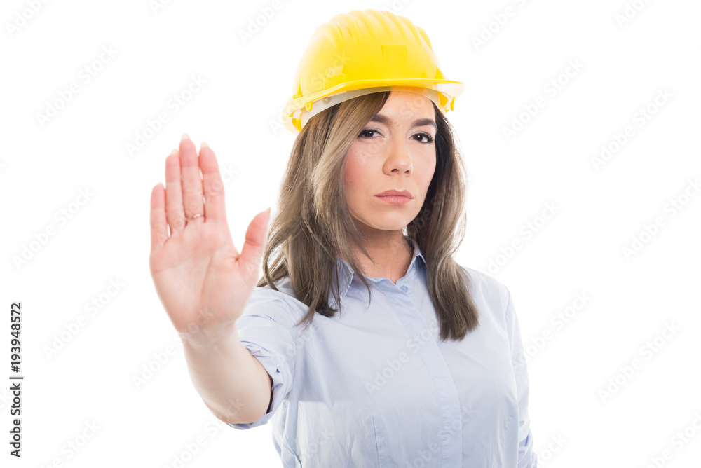 Portrait of female constructor showing stop gesture. Portrait of female constructor showing stop gesture.