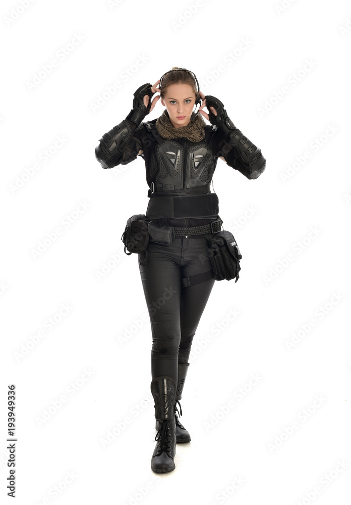 full length portrait of female soldier wearing black tactical armour, isolated on white studio background. full length portrait of female soldier wearing black tactical armour, isolated on white studio background.