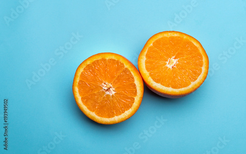 Halves of orange on blue background
