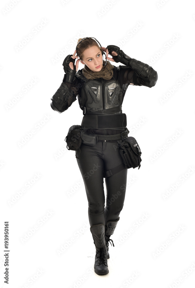 full length portrait of female soldier wearing black tactical armour,  isolated on white studio background. Stock Photo