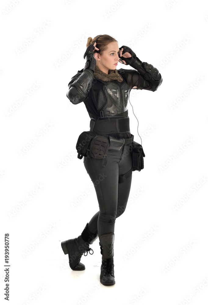 full length portrait of female soldier wearing black tactical armour, isolated on white studio background. full length portrait of female soldier wearing black tactical armour, isolated on white studio background.