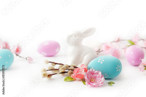 easter eggs and springg flowers on white background